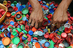 Hands sorting plastic bottle caps